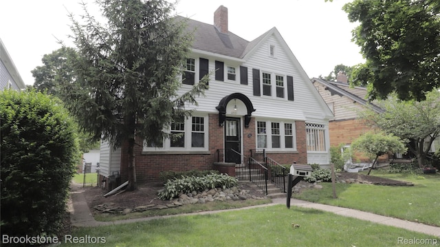 22101 Francis St, Dearborn, MI 48124 - view of front facade with brick siding, a chimney, and a front yard