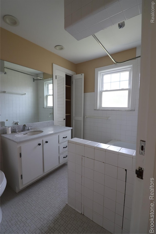 22101 Francis St, Dearborn, MI 48124 - full bathroom with tile walls, vanity, toilet, and a shower