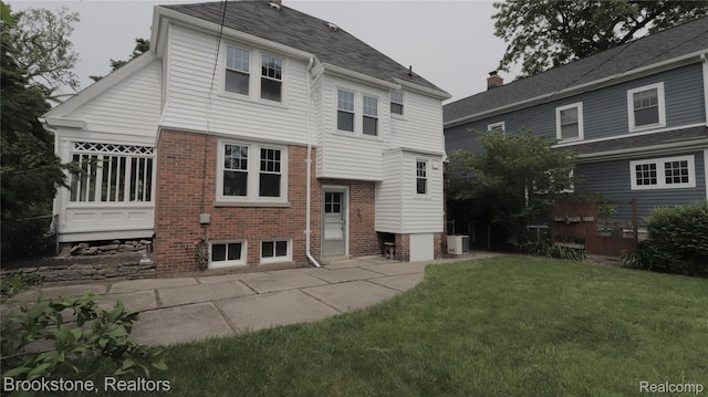 22101 Francis St, Dearborn, MI 48124 - back of house featuring central AC unit, brick siding, and a lawn