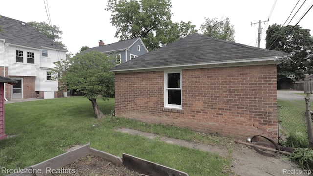 22101 Francis St, Dearborn, MI 48124 - view of side of property featuring brick siding, a lawn, and roof with shingles