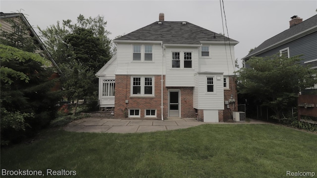 22101 Francis St, Dearborn, MI 48124 - rear view of house with central AC, a yard, brick siding, and a patio area
