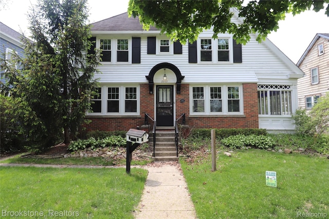 22101 Francis St, Dearborn, MI 48124 - view of front of home with brick siding and a front yard
