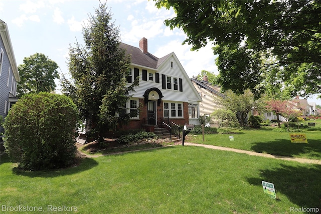 22101 Francis St, Dearborn, MI 48124 - view of front of property featuring a chimney, a front yard, and brick siding