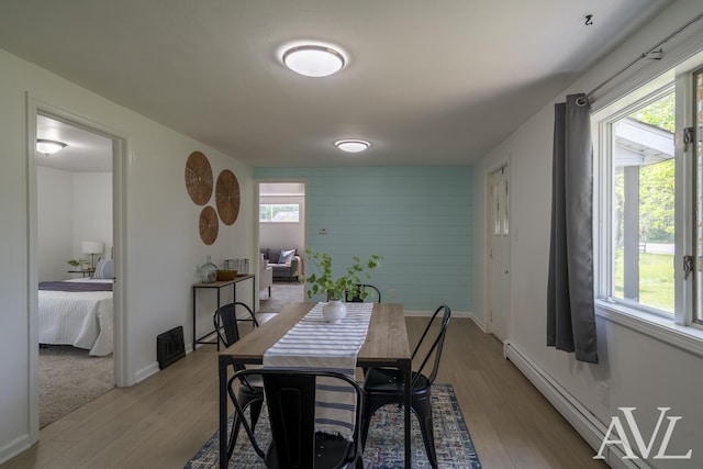7936 Whitehall Rd, Whitehall, MI 49461 - dining area with light wood-type flooring, baseboards, and a baseboard radiator