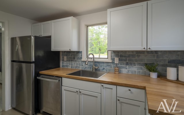 7936 Whitehall Rd, Whitehall, MI 49461 - kitchen with wooden counters, stainless steel appliances, a sink, and decorative backsplash