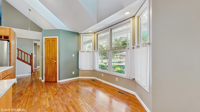 224 S Jameson St, New Buffalo, MI 49117 - spare room with high vaulted ceiling, light wood-type flooring, baseboards, and stairs