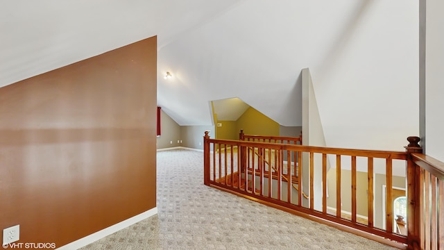 224 S Jameson St, New Buffalo, MI 49117 - hallway with an upstairs landing, vaulted ceiling, carpet, and baseboards
