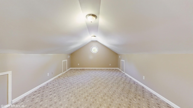 224 S Jameson St, New Buffalo, MI 49117 - additional living space with vaulted ceiling, carpet, and baseboards