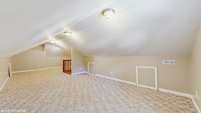 224 S Jameson St, New Buffalo, MI 49117 - additional living space featuring vaulted ceiling, baseboards, and carpet