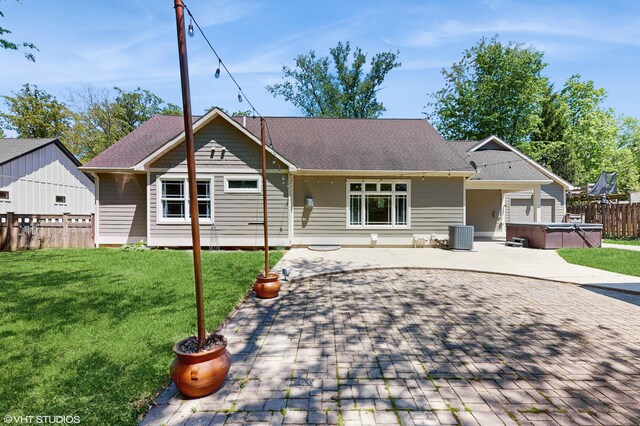 224 S Jameson St, New Buffalo, MI 49117 - view of front of house featuring a hot tub, a patio, cooling unit, and roof with shingles