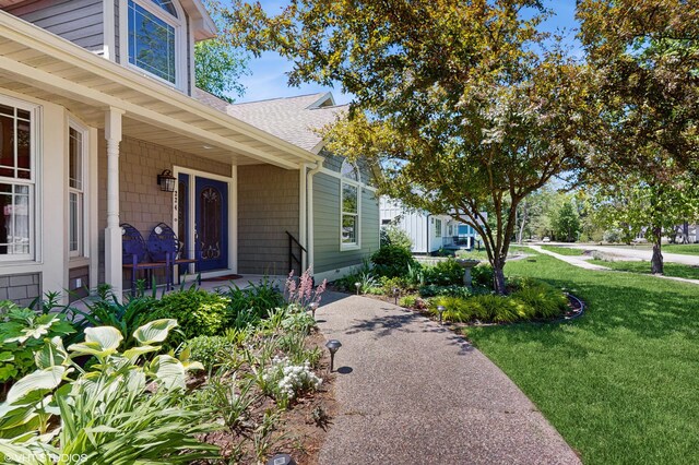 224 S Jameson St, New Buffalo, MI 49117 - property entrance featuring a shingled roof, a yard, and covered porch