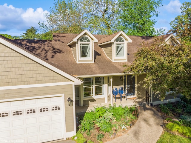 224 S Jameson St, New Buffalo, MI 49117 - view of front of property featuring an attached garage, a shingled roof, and a porch