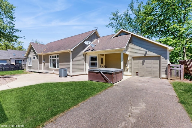 224 S Jameson St, New Buffalo, MI 49117 - ranch-style house with a hot tub, central air condition unit, driveway, a garage, and roof with shingles