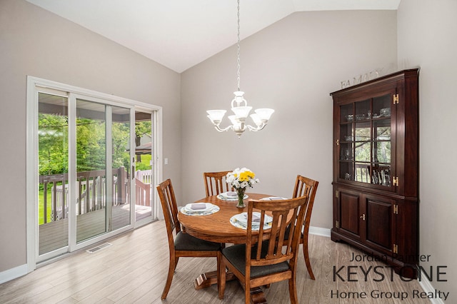 5896 Rollaway Dr NE, Comstock Park, MI 49321 - dining room with a chandelier, light wood finished floors, high vaulted ceiling, and baseboards