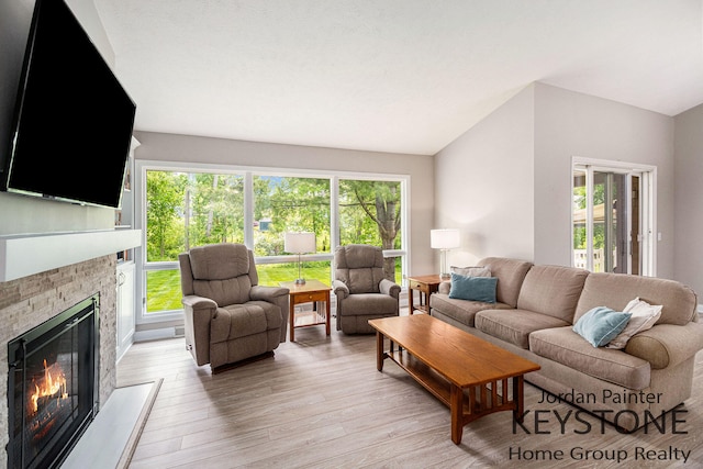 5896 Rollaway Dr NE, Comstock Park, MI 49321 - living area with a glass covered fireplace and light wood-style flooring