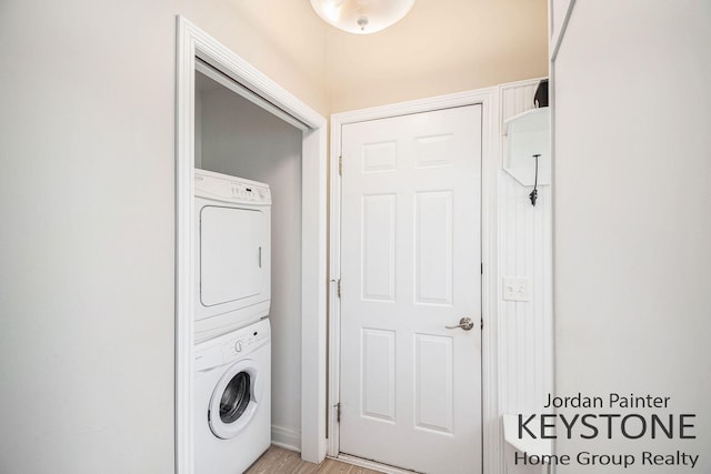 5896 Rollaway Dr NE, Comstock Park, MI 49321 - laundry room featuring estacked washer and dryer and light wood finished floors
