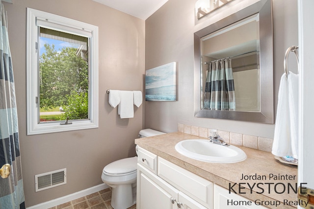 5896 Rollaway Dr NE, Comstock Park, MI 49321 - bathroom with baseboards, vanity, toilet, and a shower with shower curtain