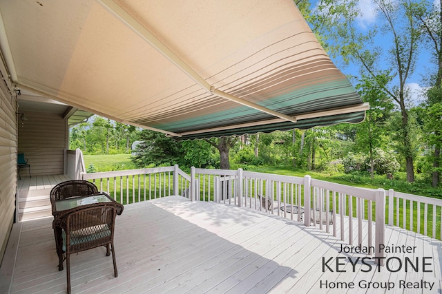 5896 Rollaway Dr NE, Comstock Park, MI 49321 - deck featuring a yard and view of wooded area