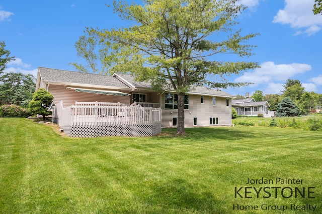 5896 Rollaway Dr NE, Comstock Park, MI 49321 - back of house with a deck and a lawn