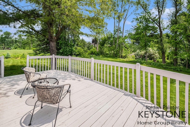 5896 Rollaway Dr NE, Comstock Park, MI 49321 - wooden deck featuring a yard and view of wooded area