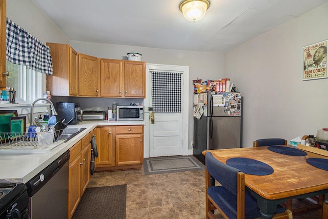 1019/1021 N Michigan Ave, Howell, MI 48843 - kitchen with appliances with stainless steel finishes, light countertops, a sink, a desk, and brown cabinets