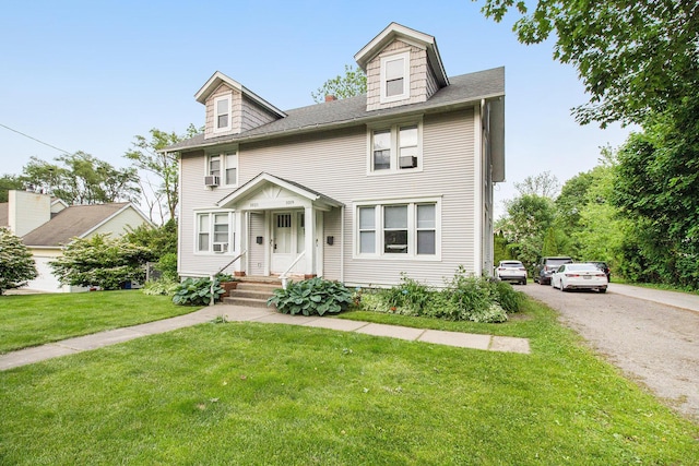 1019/1021 N Michigan Ave, Howell, MI 48843 - american foursquare style home with a front lawn and roof with shingles