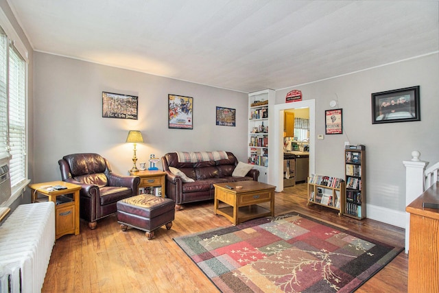 1019/1021 N Michigan Ave, Howell, MI 48843 - living room with radiator heating unit, hardwood / wood-style flooring, and built in shelves