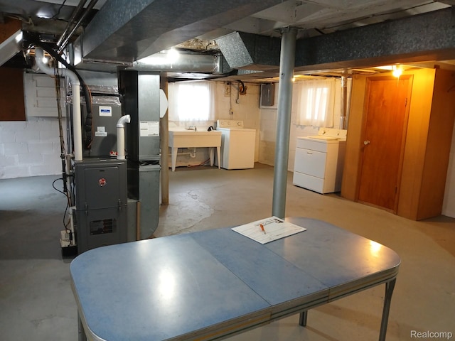113 Bondie St, Wyandotte, MI 48192 - below grade area featuring separate washer and dryer, electric panel, heating unit, and a sink