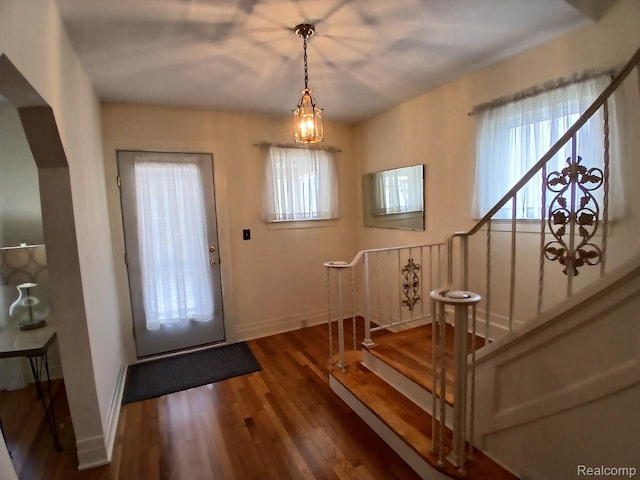 113 Bondie St, Wyandotte, MI 48192 - entrance foyer featuring baseboards, wood finished floors, stairs, and a chandelier