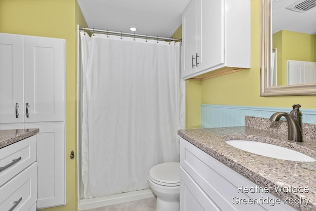 12683 Blue Lagoon Rd, Shelbyville, MI 49344 - full bath with vanity, toilet, curtained shower, tile patterned flooring, and wainscoting