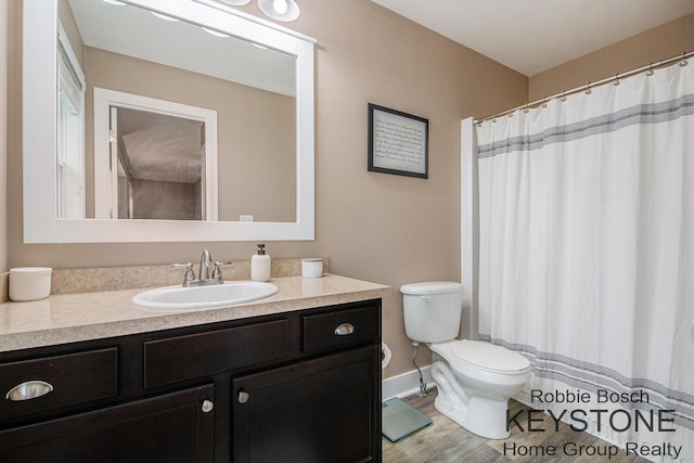 881 Cobblestone Way Dr SE, Byron Center, MI 49315 - bathroom featuring toilet, vanity, a shower with curtain, and baseboards