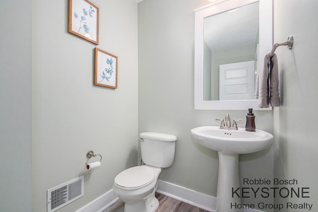 881 Cobblestone Way Dr SE, Byron Center, MI 49315 - bathroom featuring toilet, baseboards, and wood finished floors