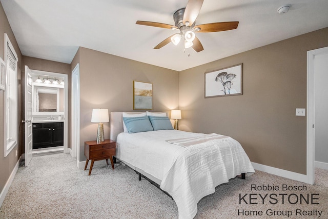 881 Cobblestone Way Dr SE, Byron Center, MI 49315 - carpeted bedroom featuring baseboards, ensuite bath, ceiling fan, and a sink