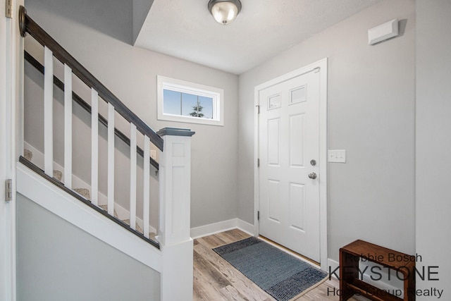 881 Cobblestone Way Dr SE, Byron Center, MI 49315 - foyer featuring light wood-style floors, stairs, and baseboards