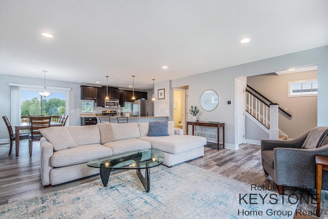 881 Cobblestone Way Dr SE, Byron Center, MI 49315 - living area with light wood-type flooring, plenty of natural light, recessed lighting, baseboards, and stairs