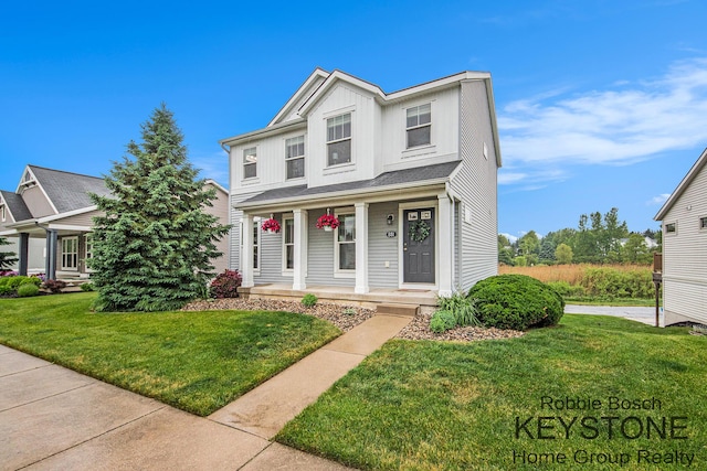 881 Cobblestone Way Dr SE, Byron Center, MI 49315 - traditional home featuring a porch and a front lawn
