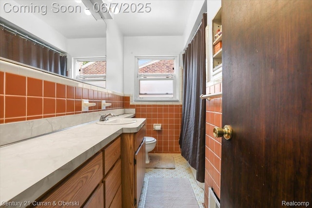6958 Whitby St, Garden City, MI 48135 - full bathroom with toilet, tile walls, vanity, a wainscoted wall, and tile patterned flooring