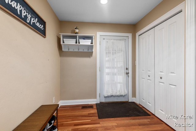 3674 Barker St, Hudsonville, MI 49426 - doorway to outside featuring wood finished floors, baseboards, and recessed lighting