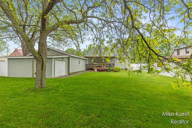 3674 Barker St, Hudsonville, MI 49426 - view of grassy yard featuring a detached garage, an outbuilding, and a deck