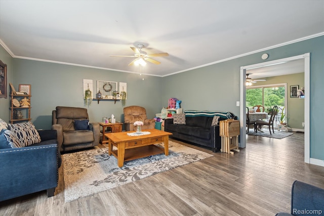 3889 Burnside Rd, Otter Lake, MI 48464 - living room featuring a ceiling fan, wood finished floors, crown molding, and baseboards