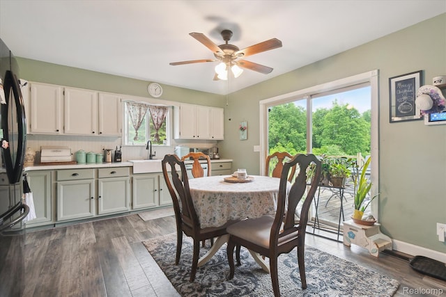 3889 Burnside Rd, Otter Lake, MI 48464 - dining area with wood finished floors, a ceiling fan, and baseboards
