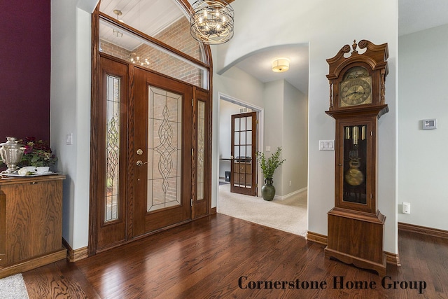 5273 S Silverstone Dr NE, Comstock Park, MI 49321 - entryway featuring arched walkways, wood finished floors, a chandelier, and baseboards