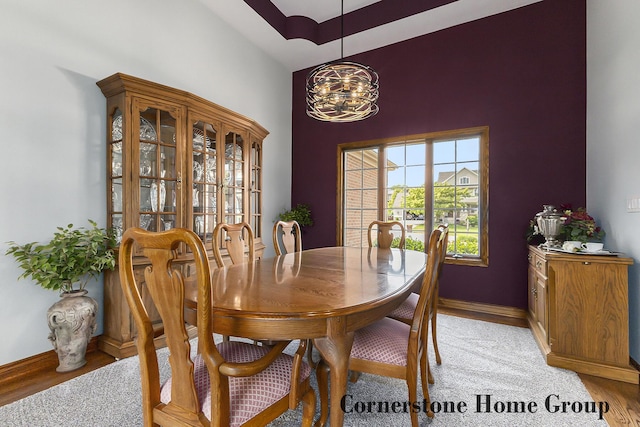 5273 S Silverstone Dr NE, Comstock Park, MI 49321 - dining room featuring a high ceiling, a chandelier, baseboards, and light wood finished floors