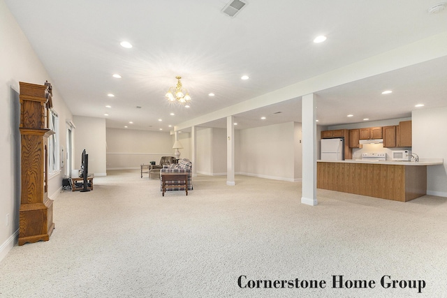 5273 S Silverstone Dr NE, Comstock Park, MI 49321 - basement with freestanding refrigerator, light colored carpet, baseboards, recessed lighting, and a chandelier