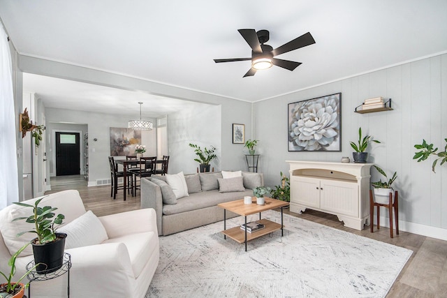 2016 Engleside Dr SE, Grand Rapids, MI 49546 - living area featuring wood finished floors, ceiling fan, baseboards, and a chandelier