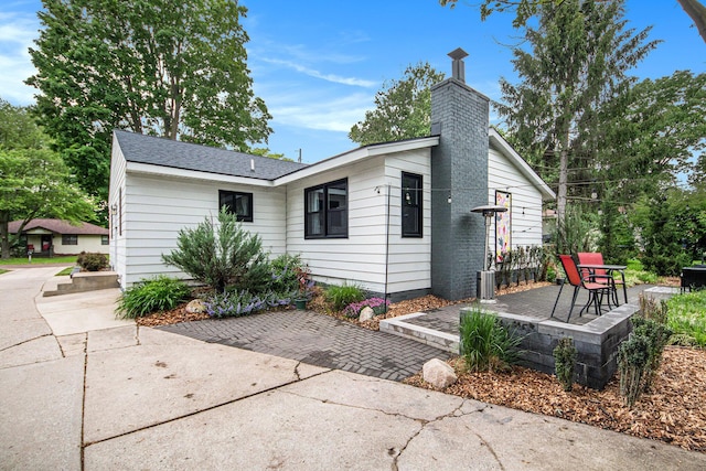 2016 Engleside Dr SE, Grand Rapids, MI 49546 - view of front of home featuring a chimney and a patio area