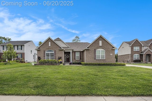 825 Mcintosh Ct, Oakland, MI 48363 - view of front facade with brick siding, a front lawn, and roof with shingles