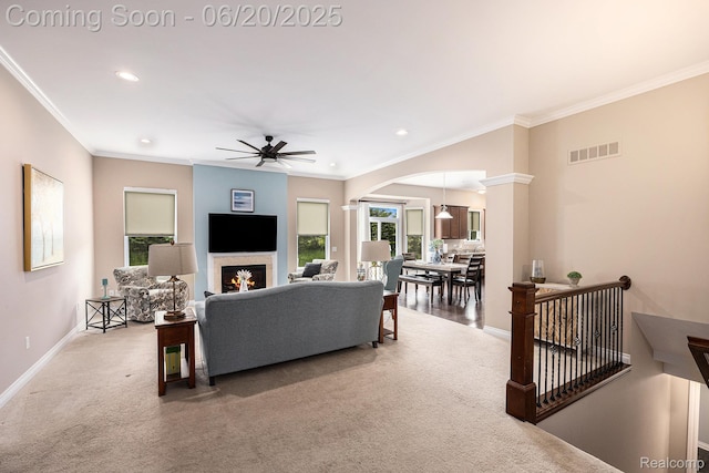 825 Mcintosh Ct, Oakland, MI 48363 - carpeted living room with ornamental molding, arched walkways, ceiling fan, a warm lit fireplace, and recessed lighting