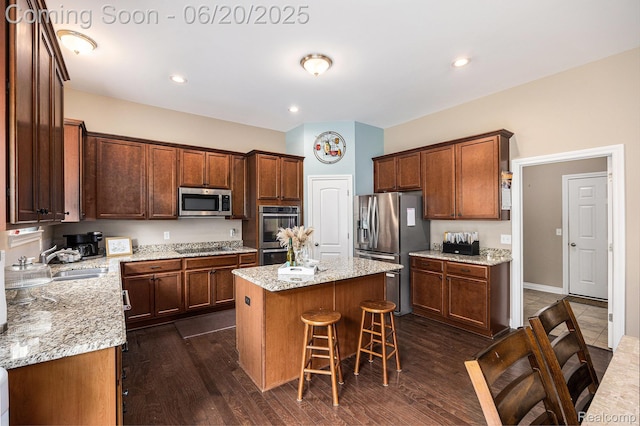 825 Mcintosh Ct, Oakland, MI 48363 - kitchen with stainless steel appliances, a center island, a kitchen bar, and light stone countertops