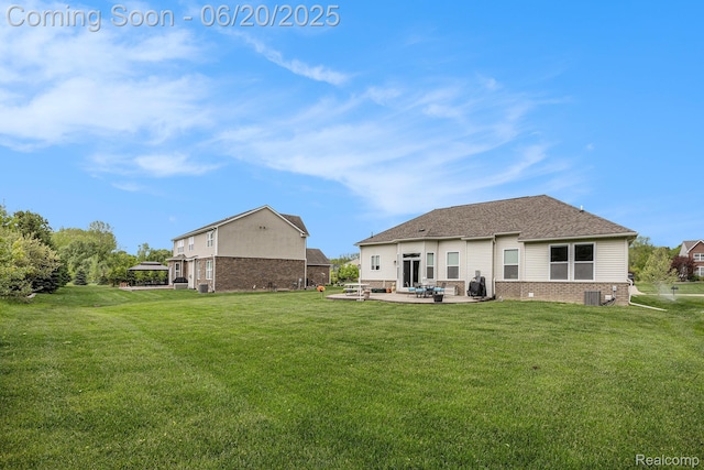 825 Mcintosh Ct, Oakland, MI 48363 - back of house with brick siding, a patio area, and a yard